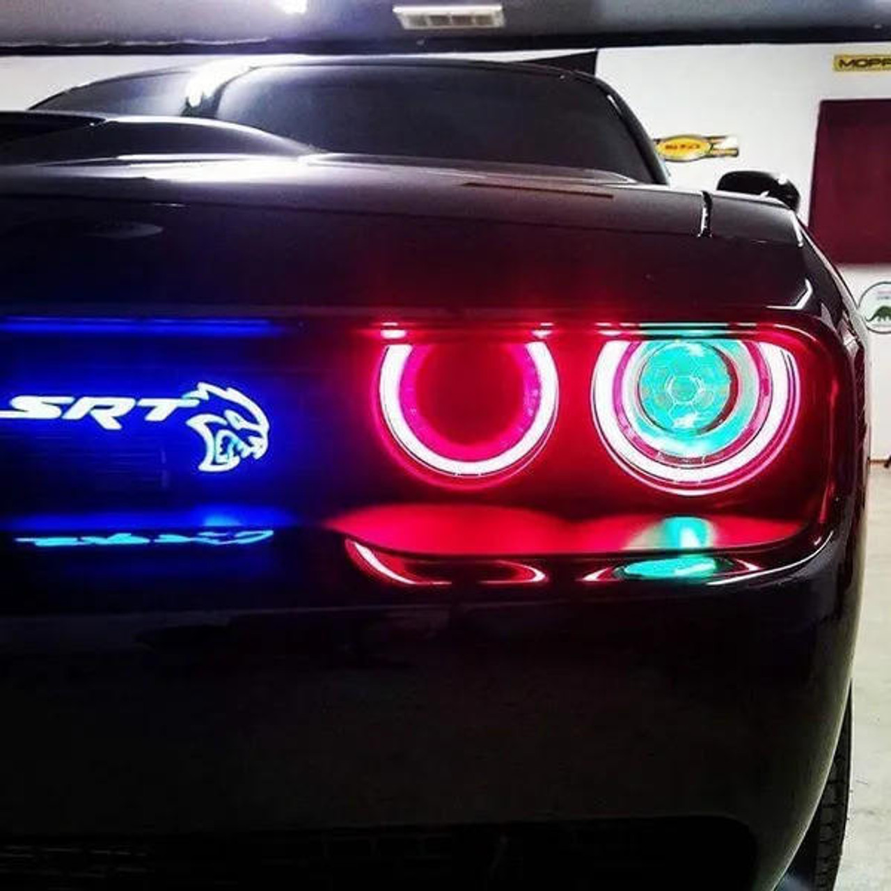 SRT Hellcat badge glowing red on a grille at night